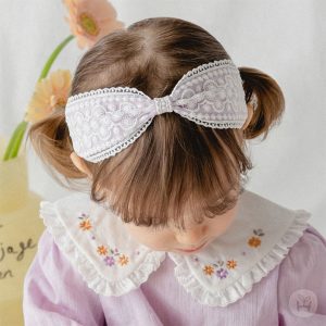 Adorable baby wearing Lolly Baby Hairpin Set with pastel-colored clips, showcasing safe and stylish hair accessories for infants