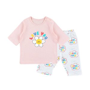 Young girl smiling in Love You Daisy Jacquard PJ Set, pink floral pajamas, part of a Buy 2, Get 1 Free promotion.