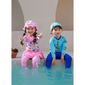 Kid wearing Surfer Croc Rashguard Swimsuit Set with crocodile print, includes blue rashguard, swim bottoms, and swim cap, perfect for children's summer aquatic adventures