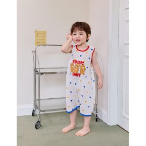 Child wearing Trois Summer Mesh Sleeping Vest with colorful hearts pattern and 'Trois Amis' design, showcasing a comfortable and playful option for toddler summer nightwear