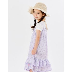 Young girl wearing a lavender floral dress with frills, paired with a white t-shirt and a straw hat, exuding summer elegance and charm.