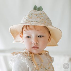 Jini Baby Girl Sun Hat featured in a serene setting, highlighting its floral design and lightweight structure, ideal for baby’s summer outings. Available now at Tiny You Baby Store