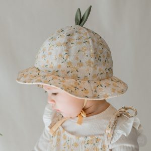 Jini Baby Girl Sun Hat featured in a serene setting, highlighting its floral design and lightweight structure, ideal for baby’s summer outings. Available now at Tiny You Baby Store