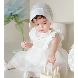 Photograph showing a baby girl dressed in the Lainie Baby Girl Bodysuit, focusing on the delicate lace details and soft fabric, perfect for special occasions