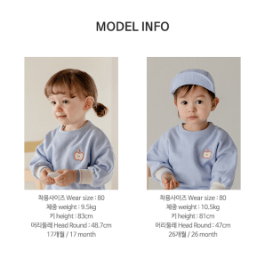 Adorable toddler in blue Onbie Baby Set-Up with apple embroidery, available at Tiny You Baby Store.