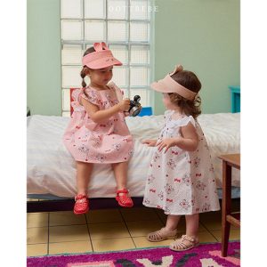 A toddler's frill dress in ivory and pink with adorable rabbit patterns, perfect for summer and outings, by OOTTBEBE.