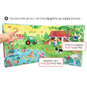 oung child pointing at a sound button in the Usborne Farmyard Sounds Book, learning animal sounds with visual and auditory stimulation